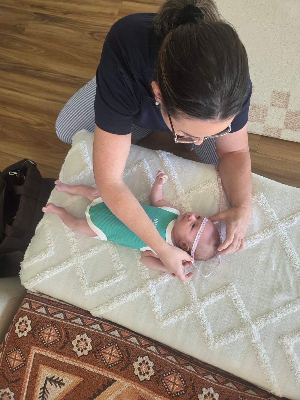 Jasmine caring for a newborn during a postnatal home visit
