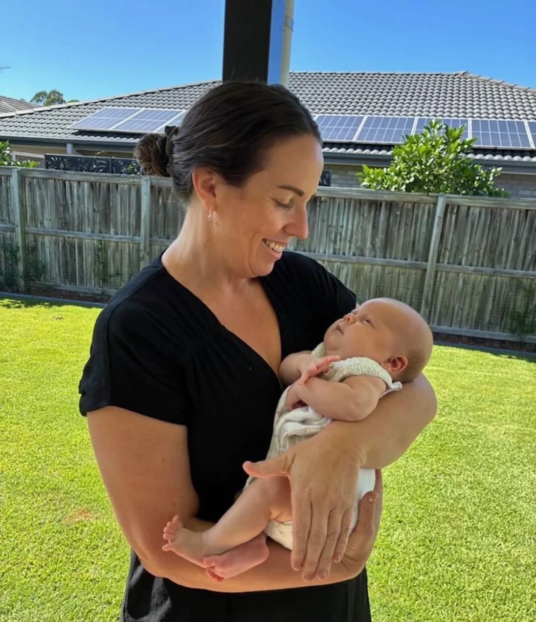 Jasmine Cunningham, Endorsed Registered Midwife, holding a newborn